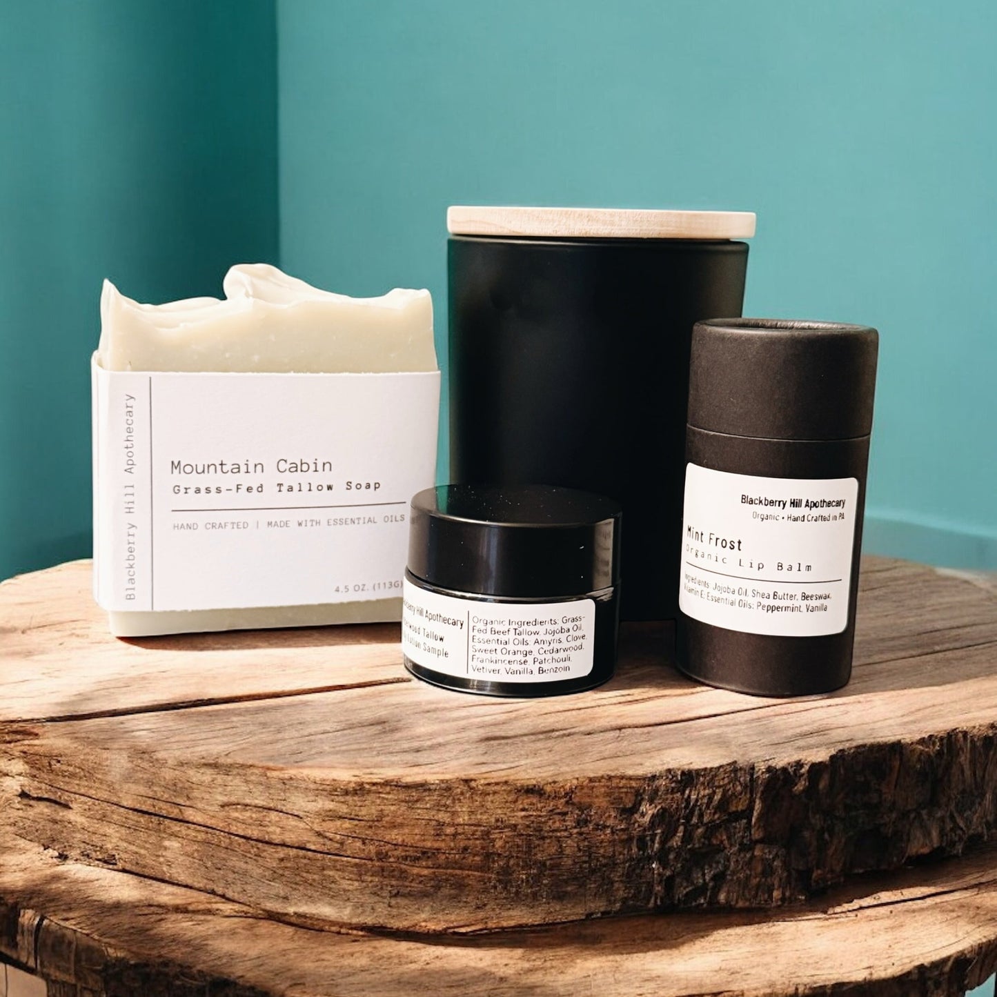 Collection of skincare products on a wooden surface with a teal wall background