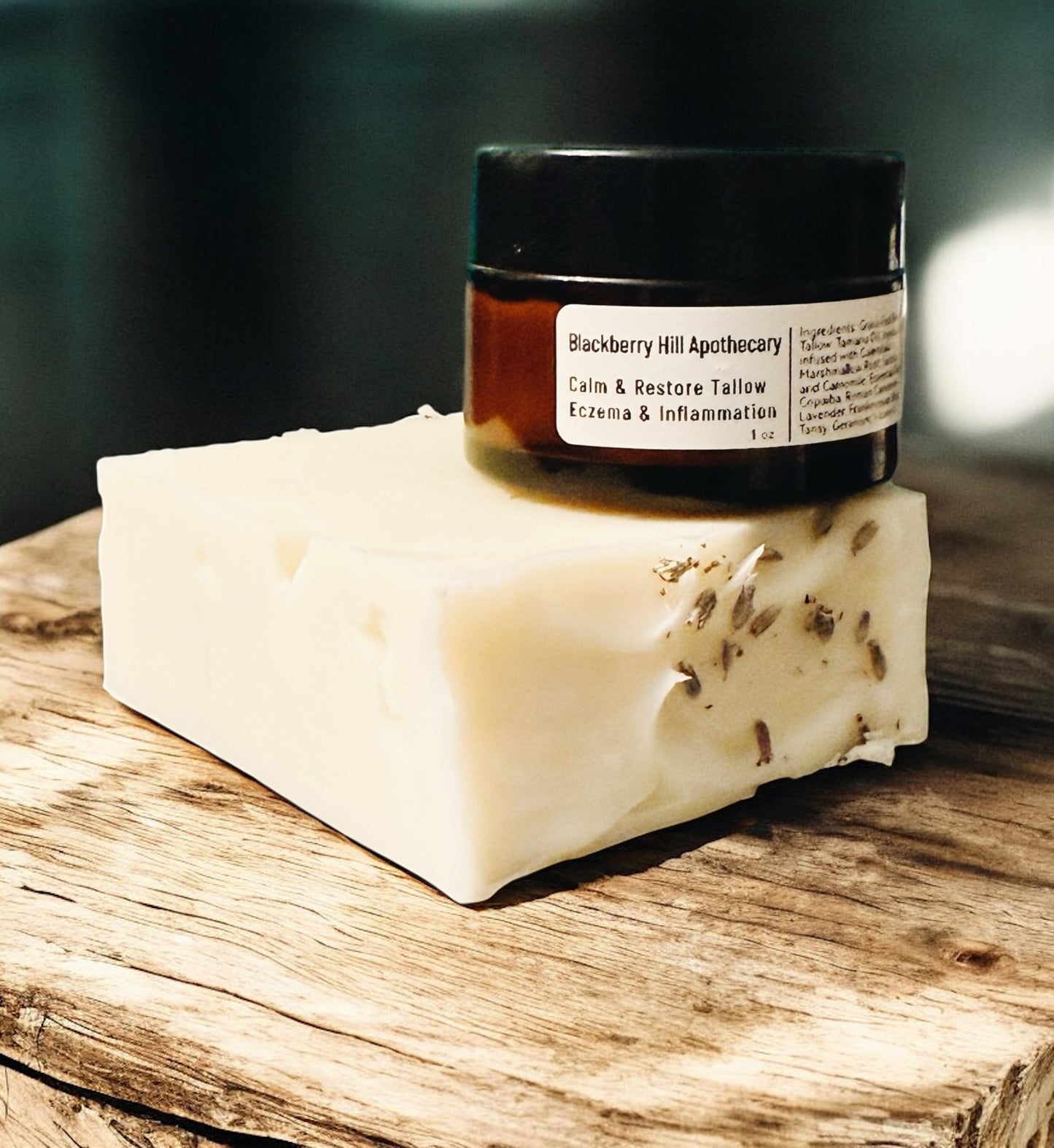 Jar of Blackberry Hill Apothecary product on a bar of soap with a dark background