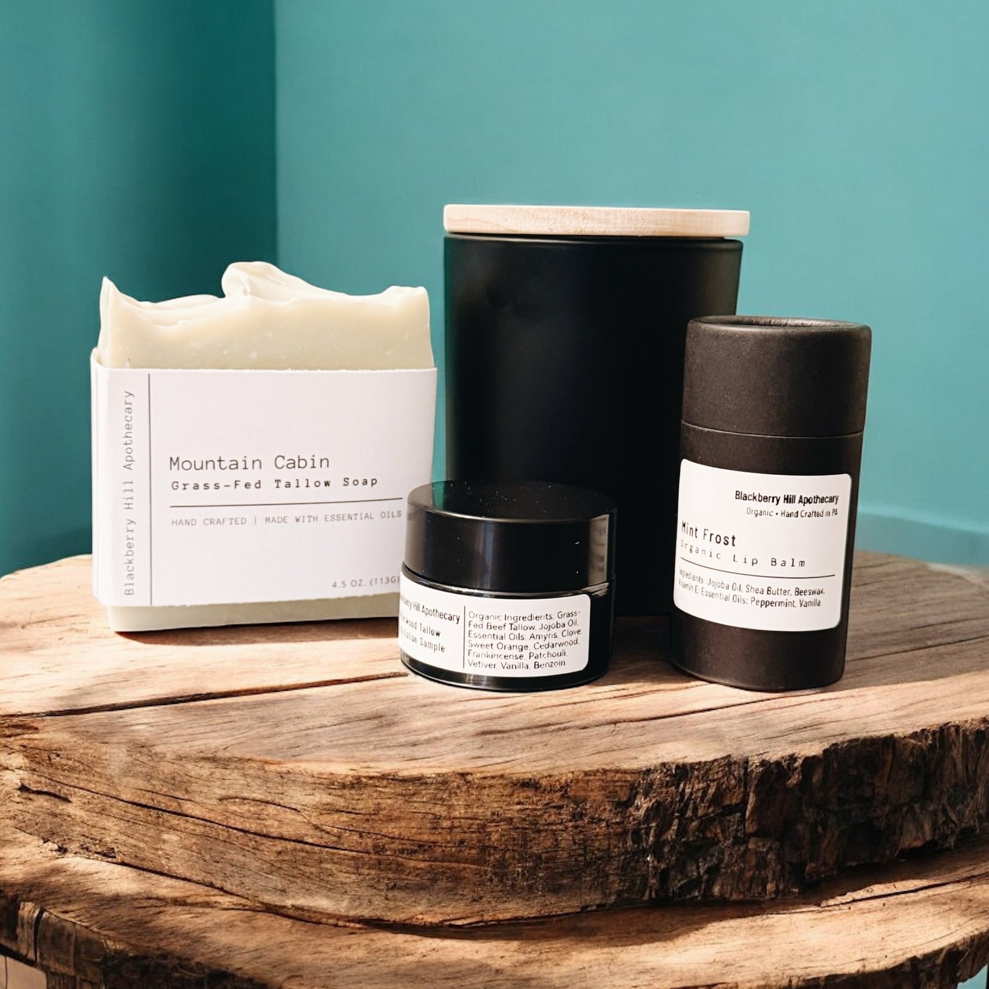 Collection of skincare products on a wooden surface with a teal wall background