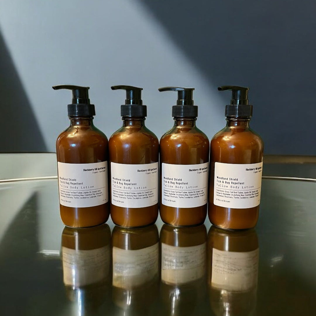 Five brown bottles with pump dispensers on a reflective surface with a dark background